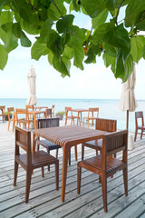 Outdoor terrace with Empty  wooden table and chair with Sea view of Indain ocean, Maldives background