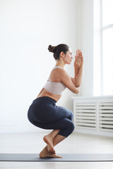 Young woman standing on exercise mat with yoga pose she meditating and relaxing