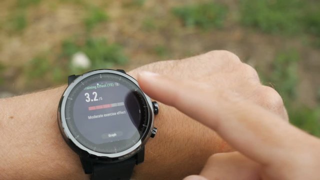 Results of a running training session on smart watch. Smartwatch. Hand with sports watch which shows results of training. Pulse, speed, distance, calories