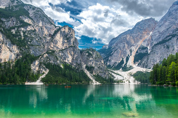 Naklejka na ściany i meble The magical lake of Braies. Emerald body of water reflects the surrounding forest and mountains. South Tyro. Italy. Europe.