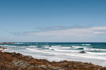 Blue ocean with waves and rocks in Australia