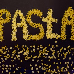 word pasta from small dry pasta. close up.