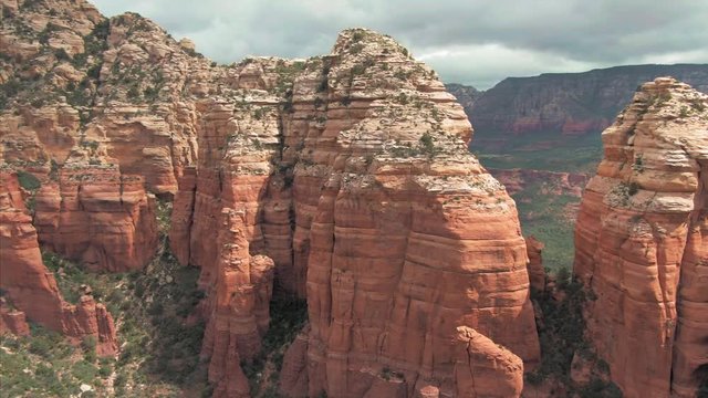 Aerial: flying over red-rock buttes in the town of Sedona, Arizona, USA