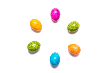 Several easter eggs in different colors on white background