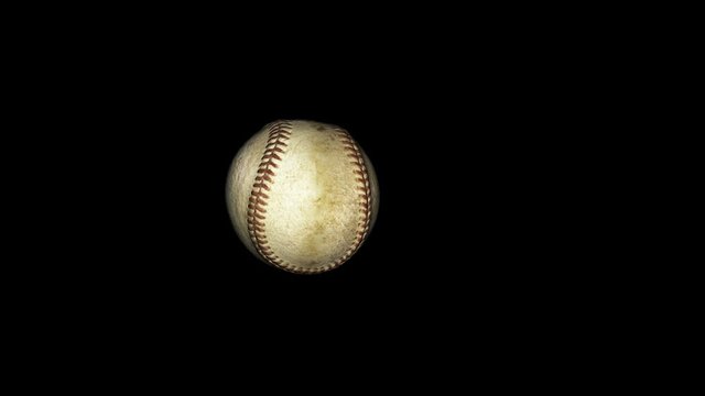 Baseball flying in slow motion against black