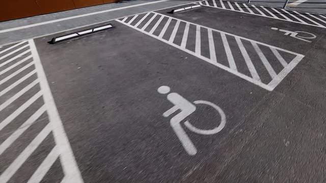 separated disabled signs on asphalt parking lots near shopping centre or mall