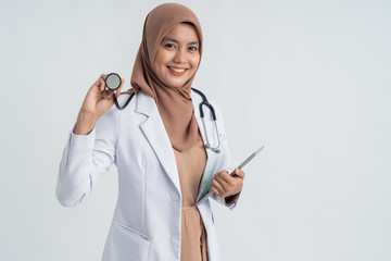 female doctor hijab using stethoscope and smile to camera over white background