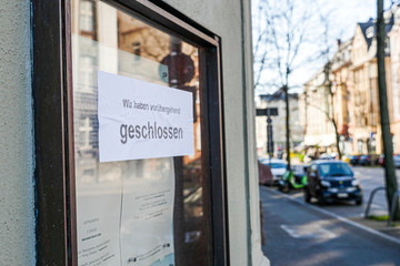 Closed Sign in German on Glass Message Board