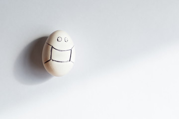 White egg in a protective mask from Covid-19. Easter concept during the coronavirus 2020 pandemic. Sad unexpectedly sadly spoiled holiday minimalism single color