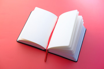 high angle view of open diary on red background 