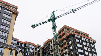 Concrete building under construction. Construction site. Crane near building.