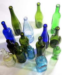 top view of a group of bottles scattered on a white background