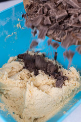 Cookie flour mixture in the bowl with black cooking chocolate