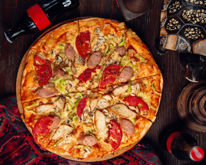 mixed pizza with sausages olives and tomato __