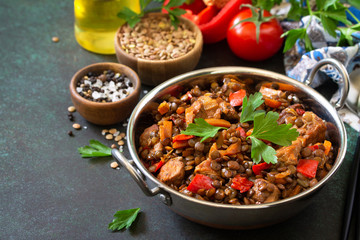 Indian food, authentic indian dish. Traditional Indian spicy green lentils with meat, spices, herbs on a stone table. Copy space.