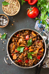 Indian food, authentic indian dish. Traditional Indian spicy green lentils with meat, spices, herbs on a stone table. Top view flat lay background.