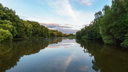 landscape view on calm Desna river in Zarechie park in Troitsk in the summer evening