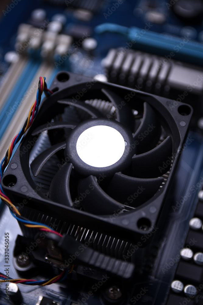 Poster computer fan on motherboard and electronical components cpu gpu memory and different sockets for vid