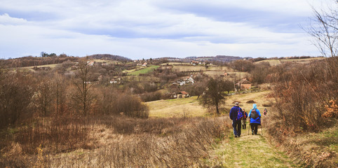 Fototapeta na wymiar active people trekking on rural landscape