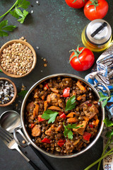 Indian food, authentic indian dish. Traditional Indian spicy green lentils with meat, spices, herbs on a stone table. Top view flat lay background. Copy space.