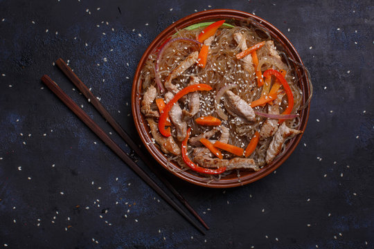 Wok pork in pad thai sauce with funcho noodles