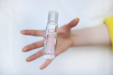 Catching bottle of sanitizer durring deficit. Washing hands with sanitizer, wearing medical mask and gloves