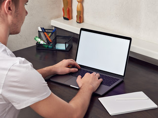Student man use laptop computer, study online, listen watch training course, make notes, e-learning...