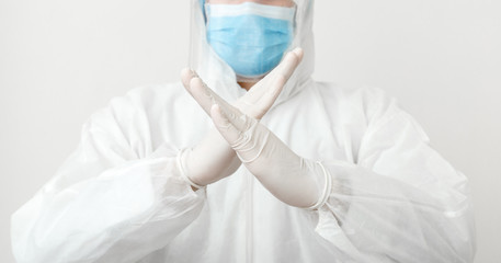 Doctor wearing protection suit and face mask show sign gesture stop pandemic epidemic of Covid-19, Coronavirus on white background. Concept of medicine health care covid coronavirus quarantine.