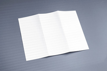 Blank opened tri-fold flyer brochure cover with shadow overlay on grey background