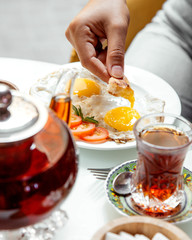 omelette and black tea on table