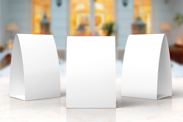 Blank paper menu table tents stands mockup on a stage or showroom for designers presentation, promotions etc.