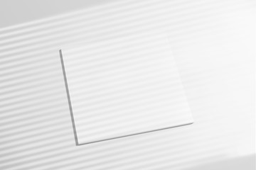High view of 3 blanc closed square magazines brochure with shadow overlay from above on white...
