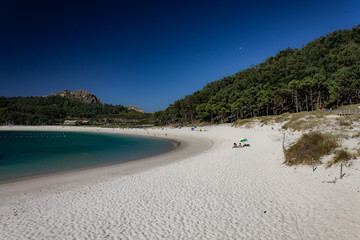 Empty beach on a pristine islands with white sand and green vegetation