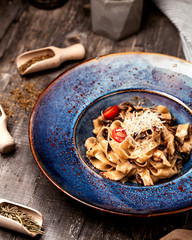 pasta with mushrooms and tomato with cheese topping