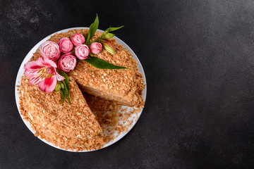 Fresh delicious cake napoleon with cream on a dark background