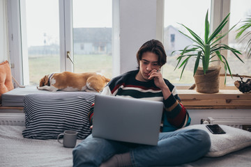 young man using laptop at home