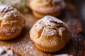 Fresh baked cupcakes of rice flour with banana and vanilla with a mug of hot chocolate