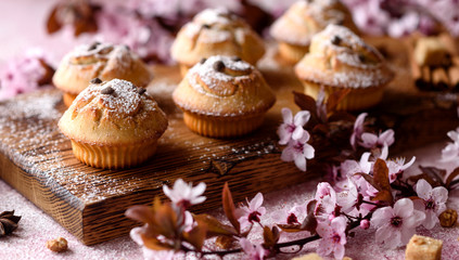 Fresh baked cupcakes of rice flour with banana and vanilla with a mug of hot chocolate