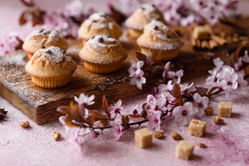 Fresh baked cupcakes of rice flour with banana and vanilla with a mug of hot chocolate