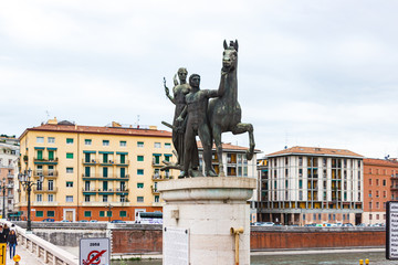 Statue of two men taming a horse on Ponte della Vittoria bridge  in Verona city, Italy.