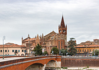 Fototapeta na wymiar View of the Church of San Fermo Maggiore, Adige river and Ponte delle Navi in old part of Verona city in Italy