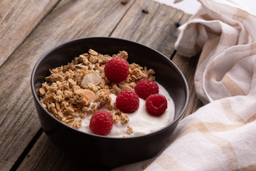  delicious breakfast with yogurt, granola and raspberries