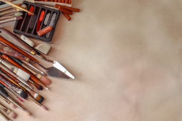 Composition with water colors, patel sticks and brushes on light paper background