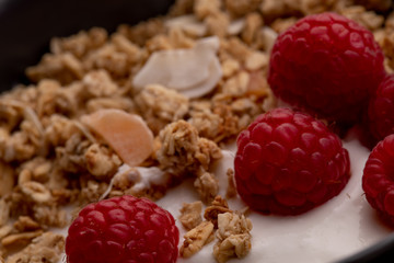  delicious breakfast with yogurt, granola and raspberries
