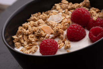  delicious breakfast with yogurt, granola and raspberries