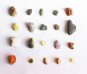 Collection of multi colored stones on white background