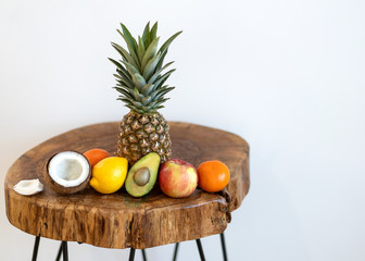 tropical fruits lie on a table on a white background