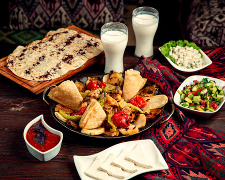 sadj with shepherd salad and glasses of ayran