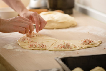 woman preparing basic dough rolls in kitchen