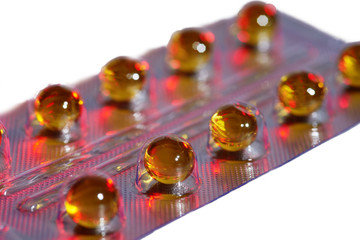 Capsules with yellow medicine on white background, isolated